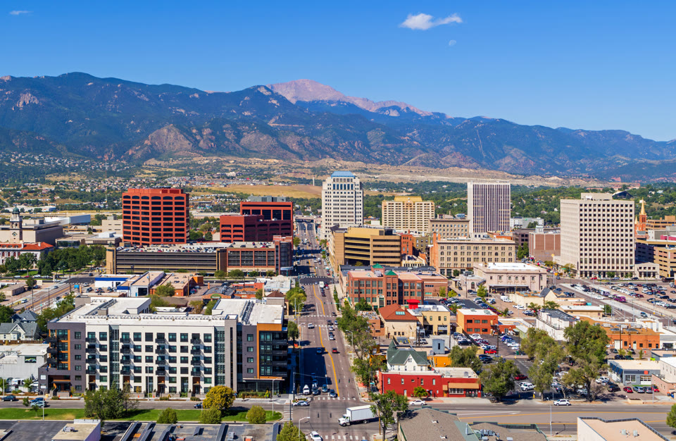 Aerial view of downtown Colorado Springs with Pikes Peak in the background