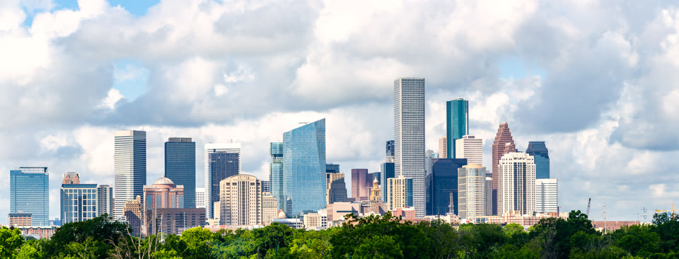Houston, Texas skyline cityscape against a partly cloudy sky