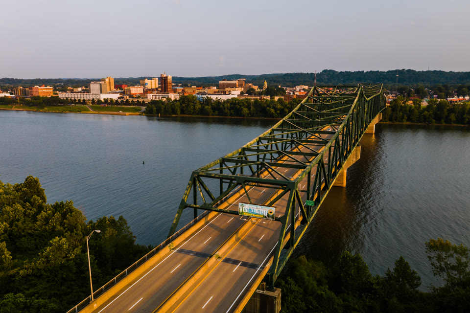 The Robert C. Byrd Bridge with a "West Virginia" sign, crossing the Ohio River into downtown Huntington, West Virginia