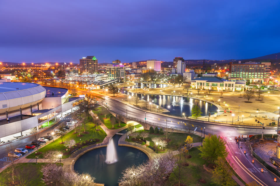 Huntsville, Alabama's Big Spring Park and downtown cityscape at dusk
