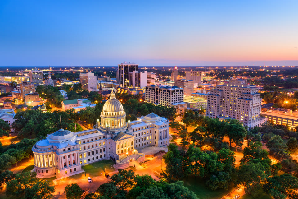 The Mississippi State Capitol dome lit up at dusk in downtown Jackson