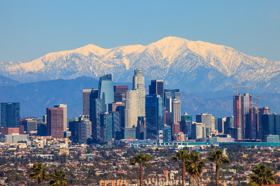 Downtown Los Angeles skyline with the snow-capped San Gabriel Mountains behind it