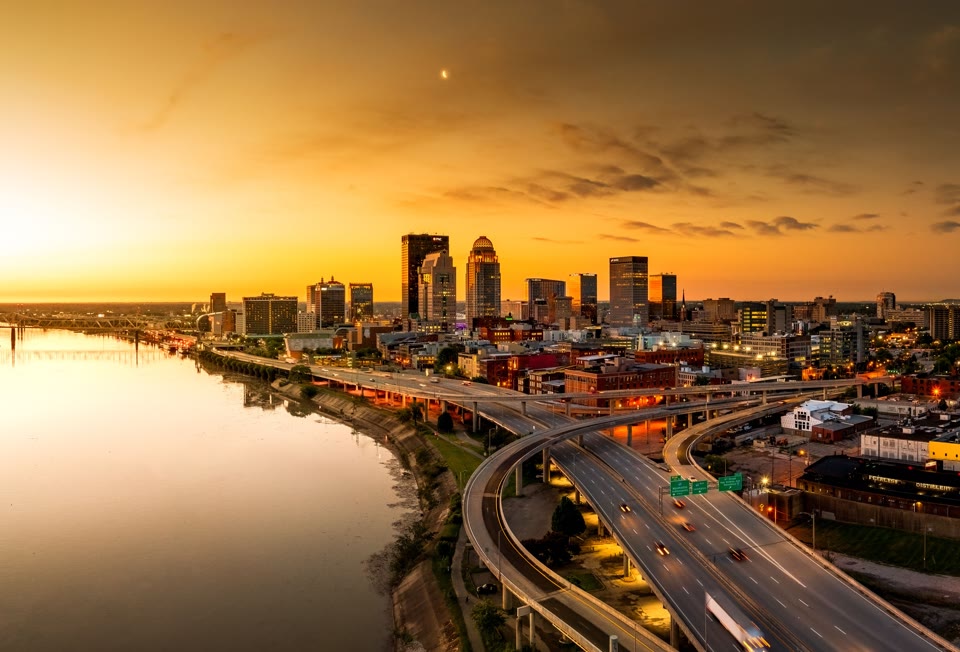 Aerial shot of the Louisville, Kentucky skyline and bridge over the Ohio River at sunrise