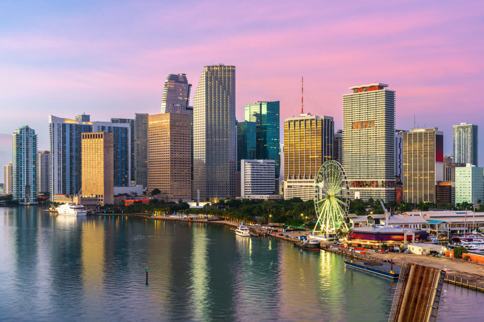 The Skyviews Miami observation wheel at Bayside Marketplace with the downtown skyline at dusk