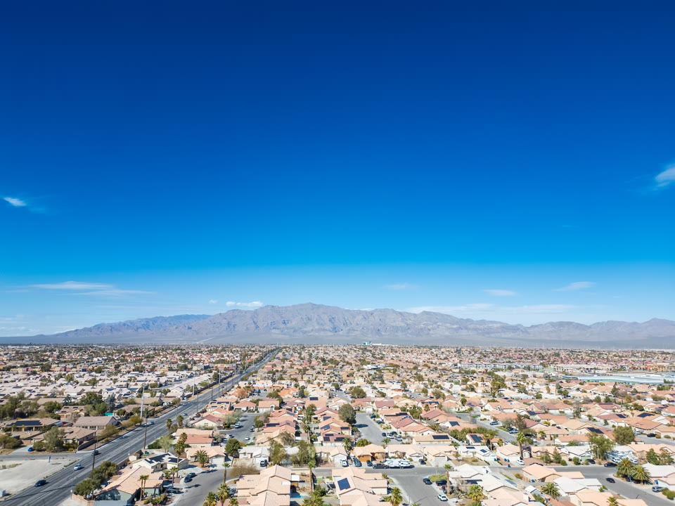 Aerial view of North Las Vegas residential neighborhoods with mountains in the background