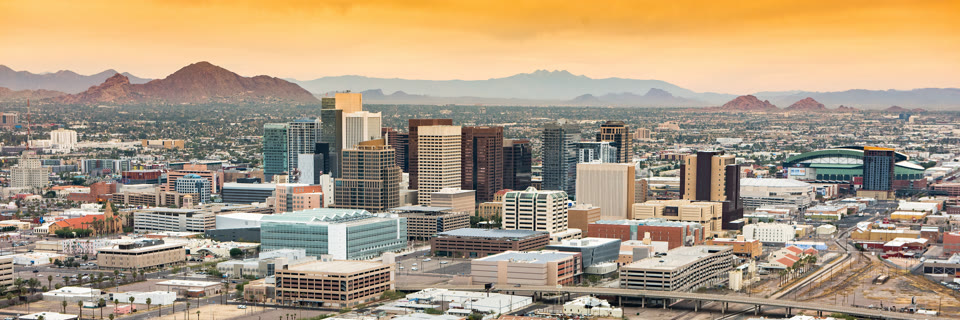 Panoramic aerial view over downtown Phoenix, Arizona with Camelback Mountain in the background