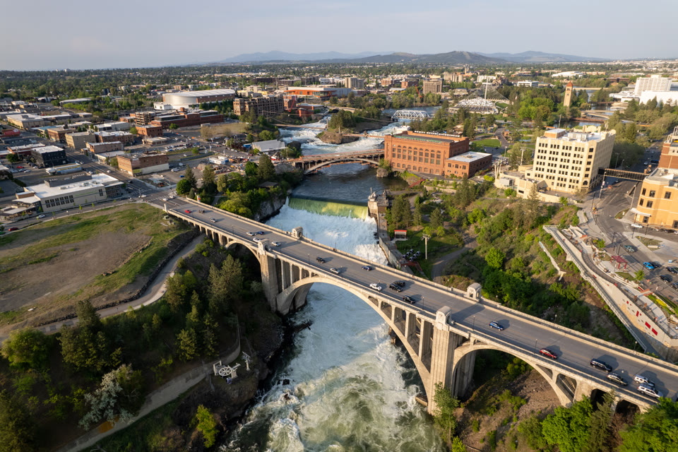 The Monroe Street Bridge over Spokane Falls with downtown Spokane, Washington behind it