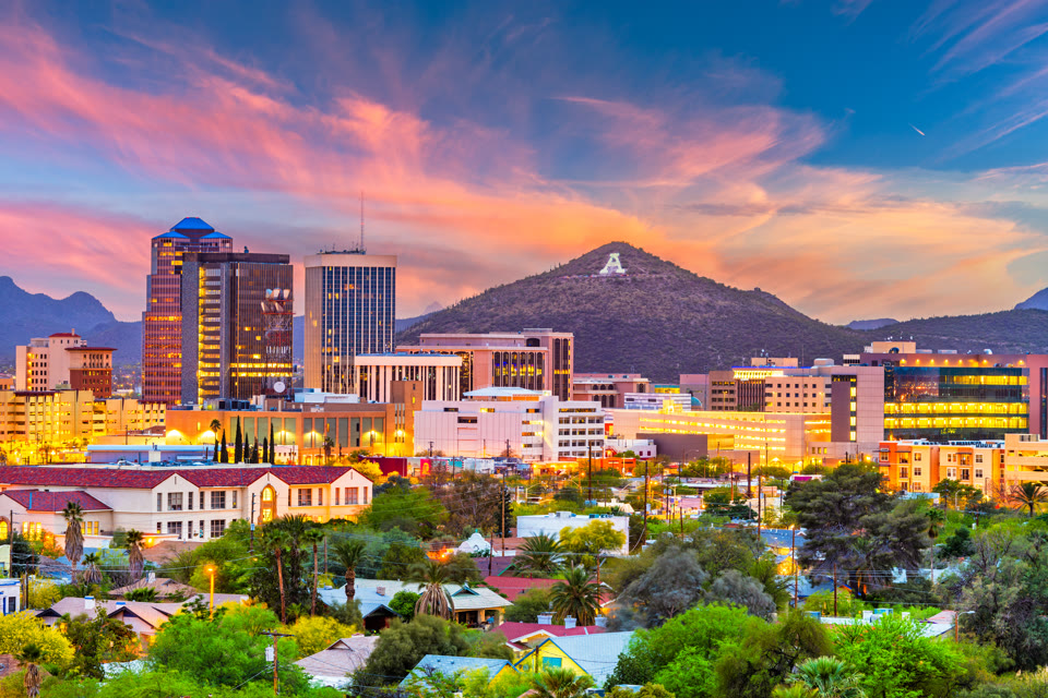 Tucson skyline at dusk with the illuminated "A" on Sentinel Peak in the background