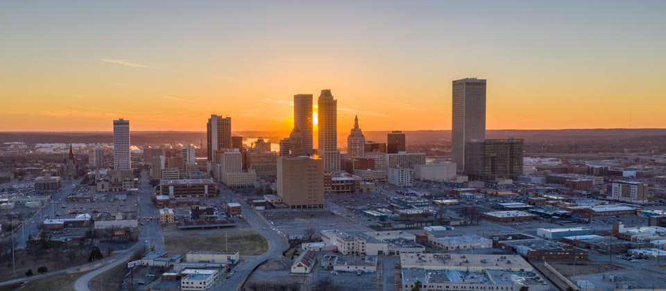 The sun setting between the Philtower and BOK Tower over downtown Tulsa, Oklahoma