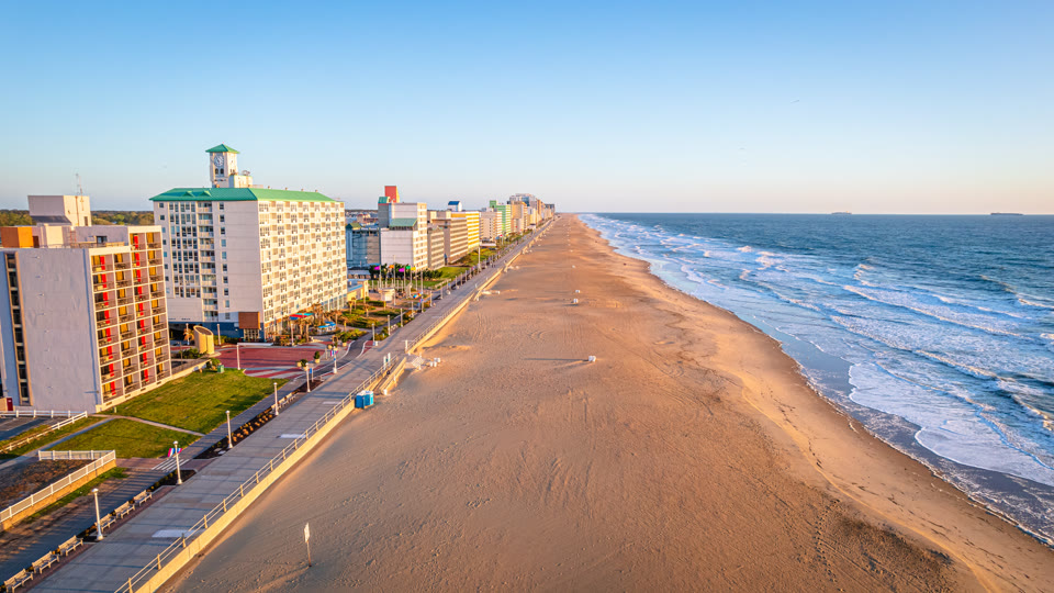 The Virginia Beach oceanfront boardwalk and hotels at sunrise